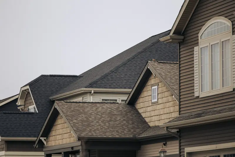 Houses with shingle roofs and gutters